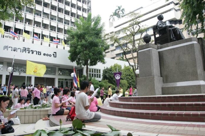 Well-wishers gather to pray Thursday at Siriraj Hospital.